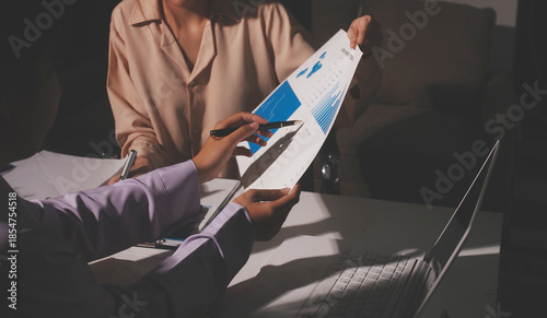 Above table with finance papers, graphs and big data during teamwork meeting with accounting or marketing team discussing budget, strategy or growth development. Closeup of SEO team doing research