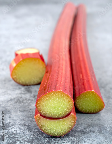 Chopped Rhubarb Stems Cross Sections on Wood Surface Close-up
