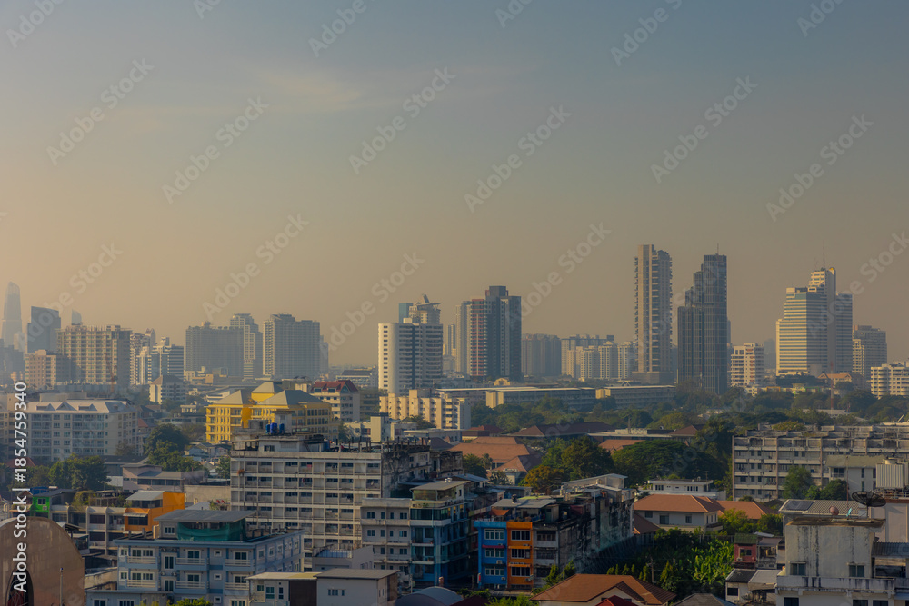 Fototapeta premium Cityscape with height buildings and construction works, Smog or dust PM 2.5 (Particulate matter with diameter of less than 2.5 micron) Bad weather and dangerous air pollution in Bangkok, Thailand.
