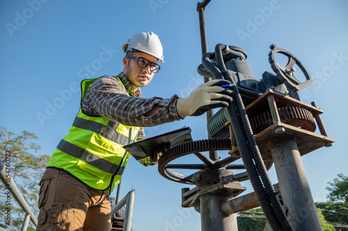 Engineer Conducting Equipment Check During Industrial Maintenance