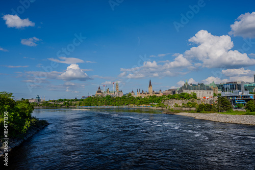 Parliament Hill and Ottawa River under a blue sky