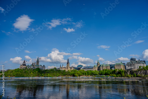 Canadian Parliament Buildings and Ottawa River under blue sky