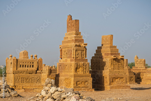Scenic landscape view of group of ancient carved golden sandstone islamic tombs, Chaukhandi graveyard, Karachi, Sindh, Pakistan