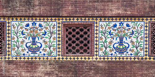 Colorful kashi-kari or faience tile mosaic floral design panels and sandstone jali on ancient mughal Wazir Khan mosque, Lahore, Punjab, Pakistan