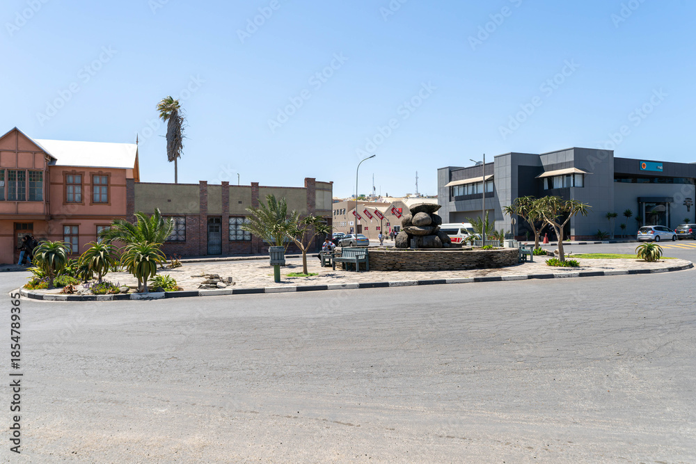 Fototapeta premium Colorful colonial buildings in Lüderitz, a small coastal town in Namibia, facing the Atlantic Ocean. Historic German architecture contrasts with desert landscapes, harbor views.