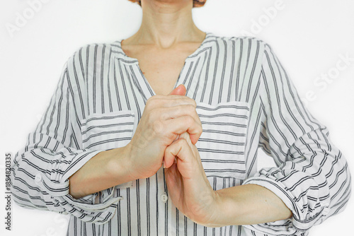 Εκτύπωση καμβά Woman grasping one hand with the other, demonstrating a self-massage and finger-stretching technique