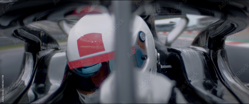 Fototapeta premium A close-up of a race car driver in motion, captured while speeding on a track