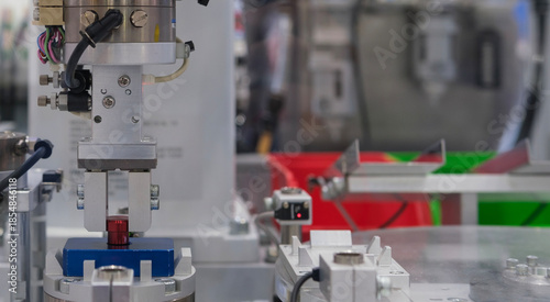 Close up industrial automation robotic working with red metalwork on smart manufacturing and right copy space, industry 4.0 and modern technology