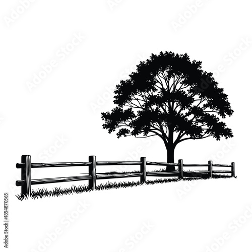 A solitary tree stands near a wooden fence against a bright background silhouette