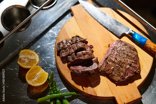 Family shares a meal of grilled meat and vegetables during iftar gathering in Ramadan evening
