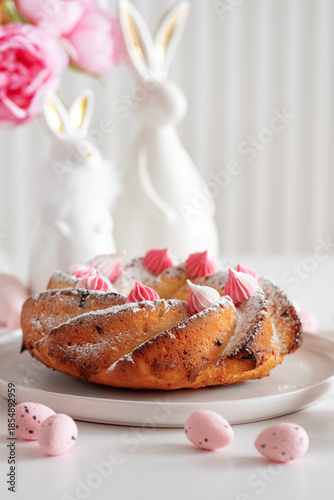 Traditional Easter cakes with icing decorated candies on white wooden table