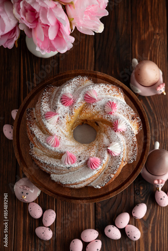 Traditional Easter cakes with icing decorated candies on dark wooden table
