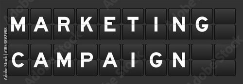 Black color analog flip board with word marketing campaign on gray background