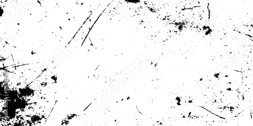 A stark textured background featuring irregular dark smudges and scratches across a predominantly white surface