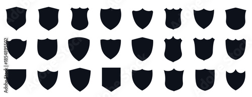 Professional collection of 24 black shield silhouettes in various shapes for logo design, security branding, and heraldic emblems.