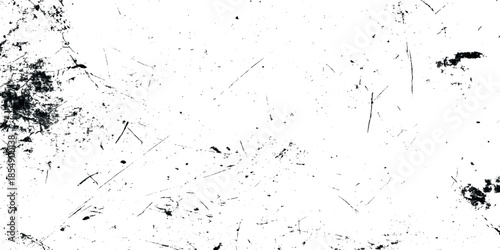 A textured monochrome image displaying a distressed surface with scratches smudges and dark irregular shapes