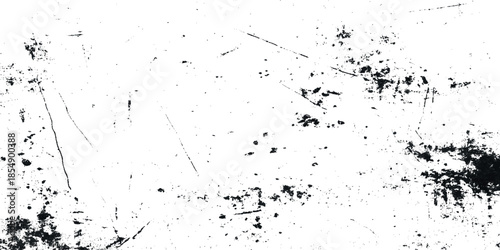 An abstract high contrast image showcasing a textured distressed surface with scattered dark markings and linear scratches