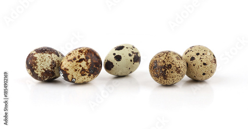 Quail eggs isolated on white background. Natural patterned farm quail eggs.