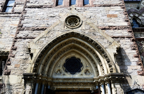 Historic Architecture: Gothic Stone Church Facade Showcasing Intricate Entrance Details Vertical