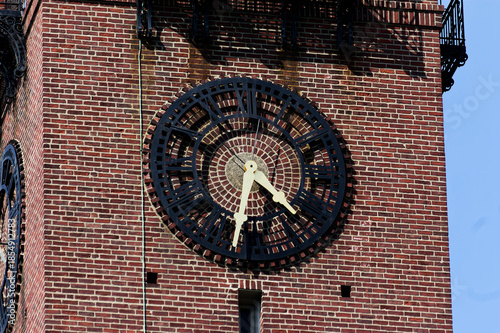 Historic Landmark Clock Tower: Ornate Clock On Red Brick Building With Iron Railings Urban Setting