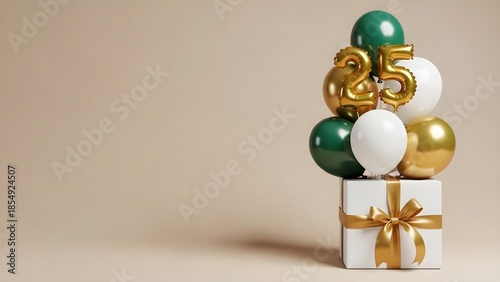 Celebrating 25 years with elegant gold and green balloons on a gift