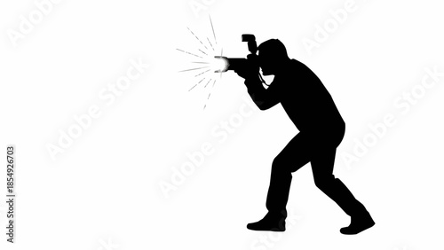 Silhouette of a photographer taking a picture with a flash.