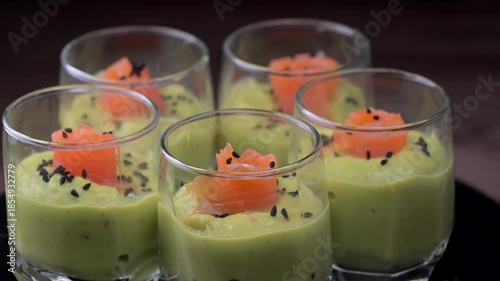 Smoked salmon shot glasses guacamole served with homemade crackers. High quality video