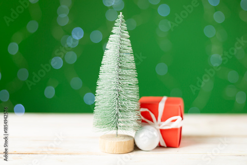 Small christmas trees on table against bokeh background