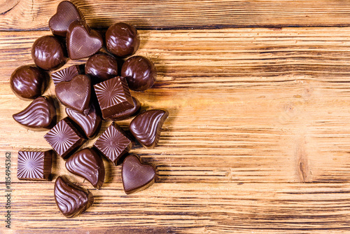 Heap of chocolate candies on a wooden table
