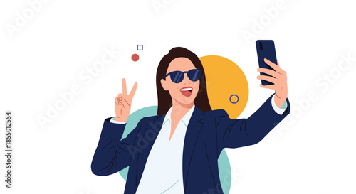 Stylish businesswoman in a blue suit and sunglasses takes a selfie while showing a peace sign for social media.