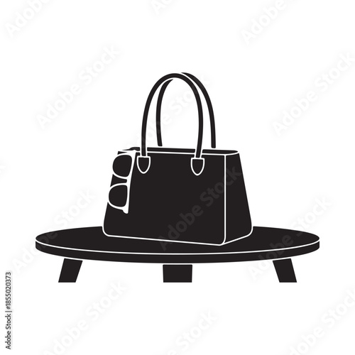 A stylish handbag and sunglasses displayed on a small round pedestal