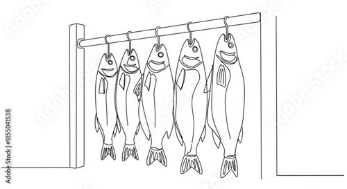 Smoked fish hanging on pole in traditional smokehouse setting  