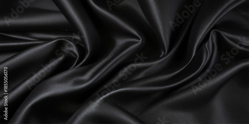 Luxurious Black Silk or Satin Texture Background with Smooth Flowing Folds, Elegant Waves, Soft Highlights, and Abstract Curved Textile Design