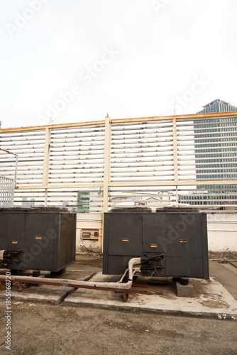 Industrial rooftop with air conditioning units and city skyline