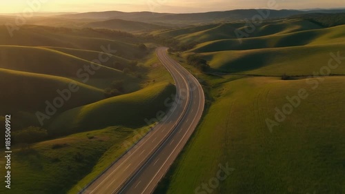 Aerial Sunset Highway Passing Through Rolling Hills