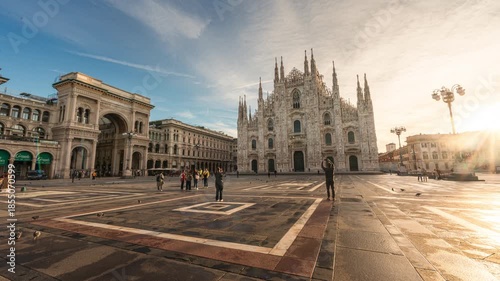 Iconic Duomo di Milano cathedral with Galleria Vittorio Emanuele II and tourists visiting in Milan, Italy