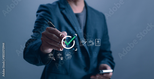 Photography Businessman signing digital approval with virtual checklist and verified documents icons