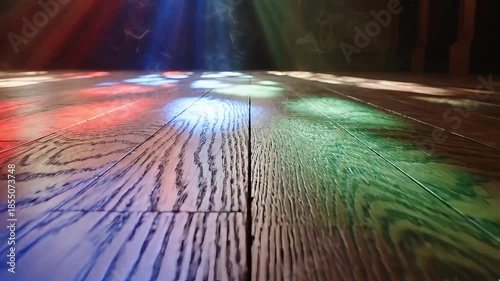Light through stained glass on wooden floor
