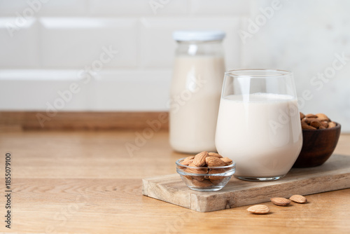 Glass of Vegan Almond Milk on Wooden Kitchen Countertop, Healthy Plant Based Nutrition Concept