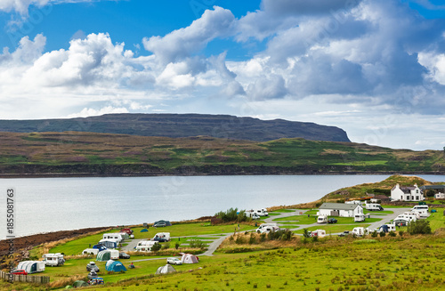 Coastal campsite with caravans beside bay in Scottish Highlands