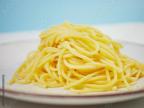 Wallpaper Mural Cooked spaghetti served on a clean white plate with soft natural lighting, showing smooth pasta texture and simple food styling for ingredient or meal visuals, pro photo Torontodigital.ca