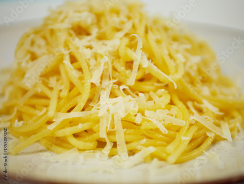 Wallpaper Mural Closeup view of cooked spaghetti covered with grated parmesan cheese on a white plate, warm cheesy pasta portion for Italian comfort food and restaurant menu visuals Torontodigital.ca