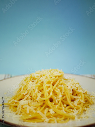 Wallpaper Mural Plate of spaghetti with grated parmesan cheese on blue and white background, vertical Italian pasta image for restaurant posters, menus and social media content Torontodigital.ca