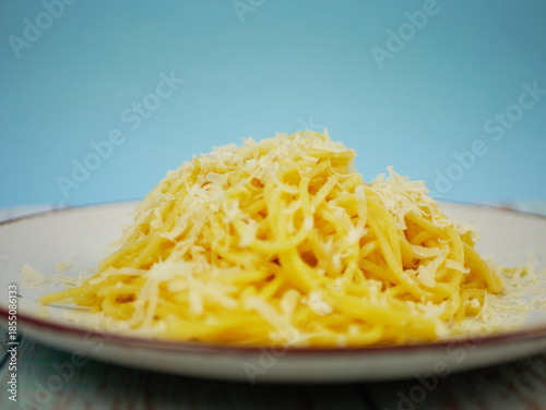 Wallpaper Mural Plate of spaghetti with grated parmesan cheese on blue and white background, vertical Italian pasta image for restaurant posters, menus and social media content. Pro Photo Torontodigital.ca