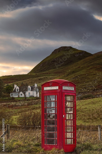 Red telephone booth next to the A855 road in Brogaig village at the foot of the Quiraing landform, old K6 model still operational. Skye-Scotland-177