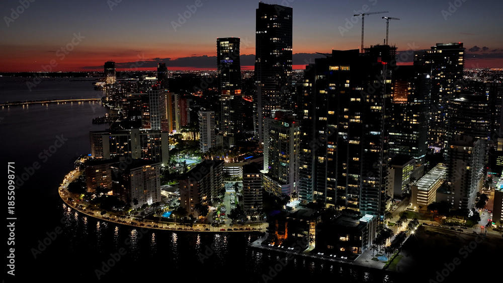 Naklejka premium Miami Skyline At Miami In Florida United States. Illuminated City. Night City Scenery. Downtown District. Miami Skyline In Florida United States. Stunning Cityscape.