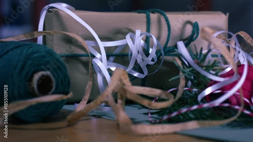 Christmas gift with wrapping ribbon and string green background