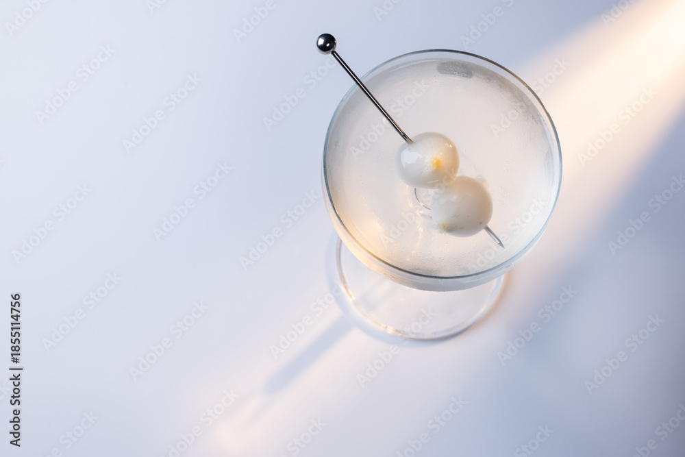 custom made wallpaper toronto digitalGibson martini on a reflective white surface with high contrast lighting and contrasting tones.