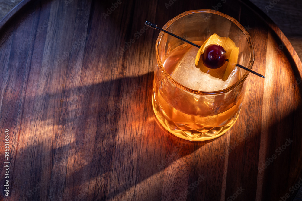 custom made wallpaper toronto digitalwhiskey cocktail served on the rocks garnished with an orange peel anda cherry with dramatic lighting served on a wooden surface.