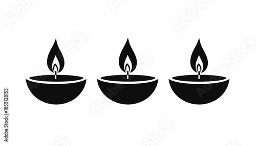 Three Diwali oil lamps in a row on a white background.